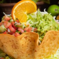 Taco Salad · Your choice of seasoned ground beef or shredded chicken stuffed into a crisp tortilla with r...