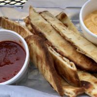 Flatsticks · Oven-fresh, crispy flat-bread strips served with your choice of Dad’s own tomato sauce or ch...
