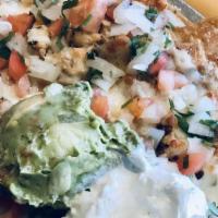 Chicken Nachos · Tortilla chips with cheese, guacamole, pico de gallo and sour cream