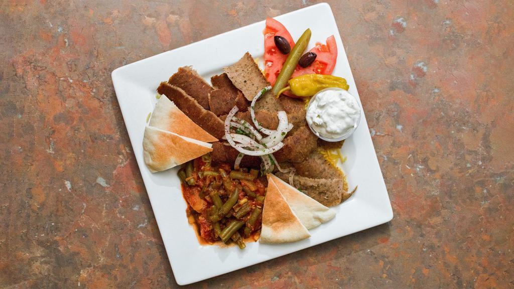 Gyro Dinner · Rotisserie beef and lamb slices served with rice, green beans, tzatziki sauce, and pita.