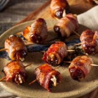 Bacon Wrapped Tots · 2 skewers of tots wrapped with bacon and jalapeño peppers. Topped with cheddar cheese and gr...