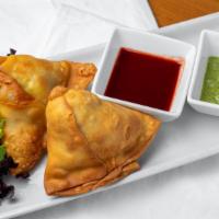 Vegetable Samosa · Triangular-shaped pastry stuffed with fresh herbs, spices, and vegetables.