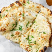 Garlic Naan · Curri's signature naan, made with garlic and butter.