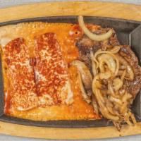 Enchiladas Carne Azteca · Grilled rib eye steak with onions over two cheese enchiladas smothered with red sauce. Serve...