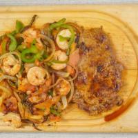 Mar & Tierra Fajita · Grilled rib eye steak topped with shrimp cooked with bell peppers, onions, and tomatoes. Ser...