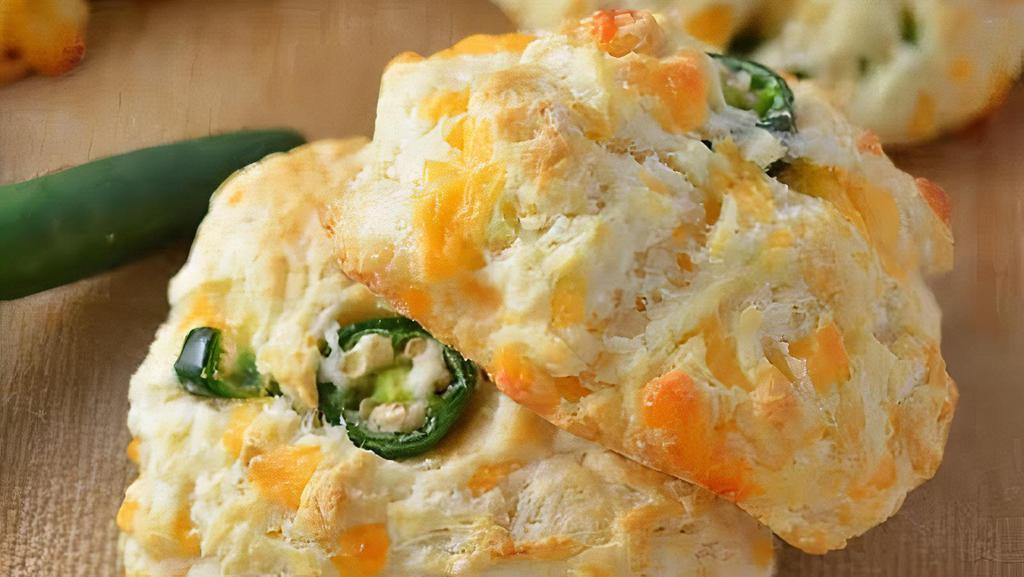 Jalapeño Queso Biscuit · Customer favorite. Our Jalapeño Queso Biscuits are inspired by a 100 year old recipe from a women's auxillary group in Georgia. Each batch is hand turned to maximize the lightness of each biscuit.  We use house-pickled jalapeños and fresh queso cheese from a traditional Mexican grocery store. Gets you a bakers dozen (13 biscuits)!