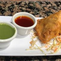Samosa · Two pieces of fried crispy shells stuffed with spicy potatoes, peas, and coriander. Served w...