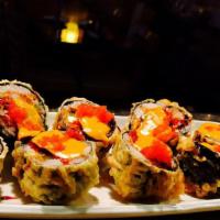 Dynamite (8 Pc) · Deep fried salmon, crab, asparagus cream cheese and spicy sauce with masago on top.