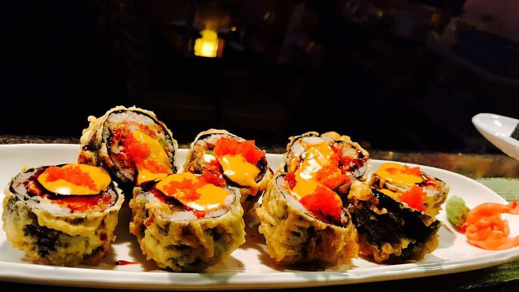 Dynamite (8 Pc) · Deep fried salmon, crab, asparagus cream cheese and spicy sauce with masago on top.