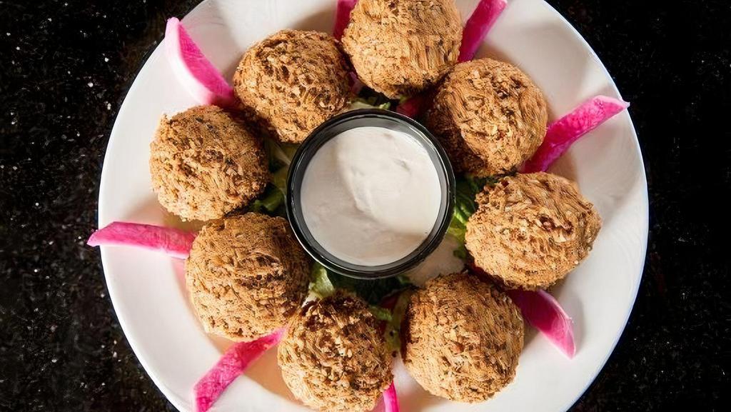 Falafel Platter · Eight pieces. A mixture of ground chickpeas, vegetables, and deep fried with spices. Served with pickled turnips and tahini sauce.