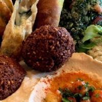 Combination Appetizer · A generous taste of baba ghanoush, hummus, tabouleh salad, Jibneh Roll, and falafel. Served ...