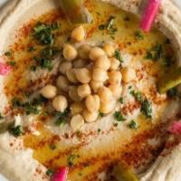 Regular Hummus · Chickpeas pureed with tahini, lemon juice, olive oil, fresh garlic, and paprika.