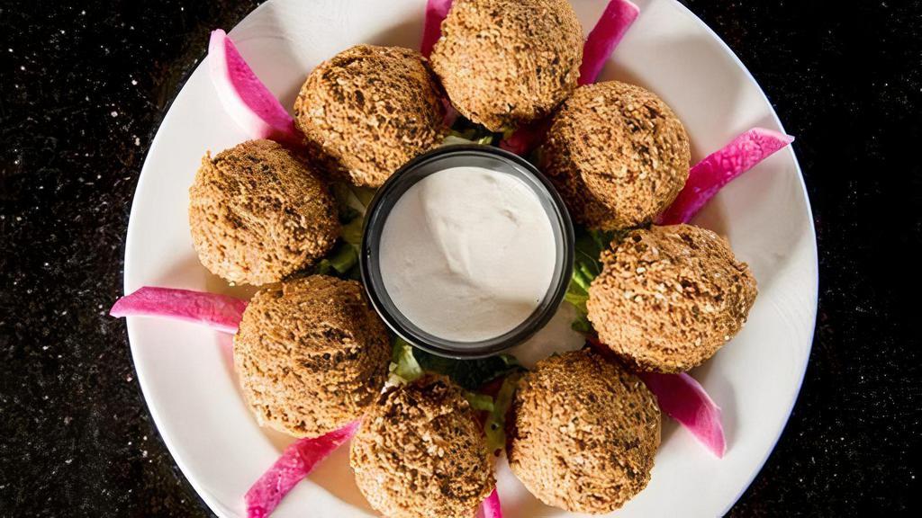 Regular Falafel Platter · A mixture of ground chickpeas and vegetables, deep-fried with spices.  Served with pickled turnips and tahini sauce, along with fresh pita bread.