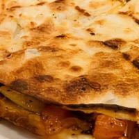 Casadilla · Beef Shawarma, mozzarella and cheddar cheese, tomatoes, onion and cilantro. Served with a si...