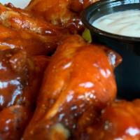 Casa Wings (6 Pc) · Bone in Chicken Wings tossed in our house made Buffalo tahini sauce, served with a side of r...