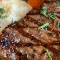 New York Strip · 12 oz. tender New York Strip topped with caramelized onions and sauteed mushrooms. Served wi...