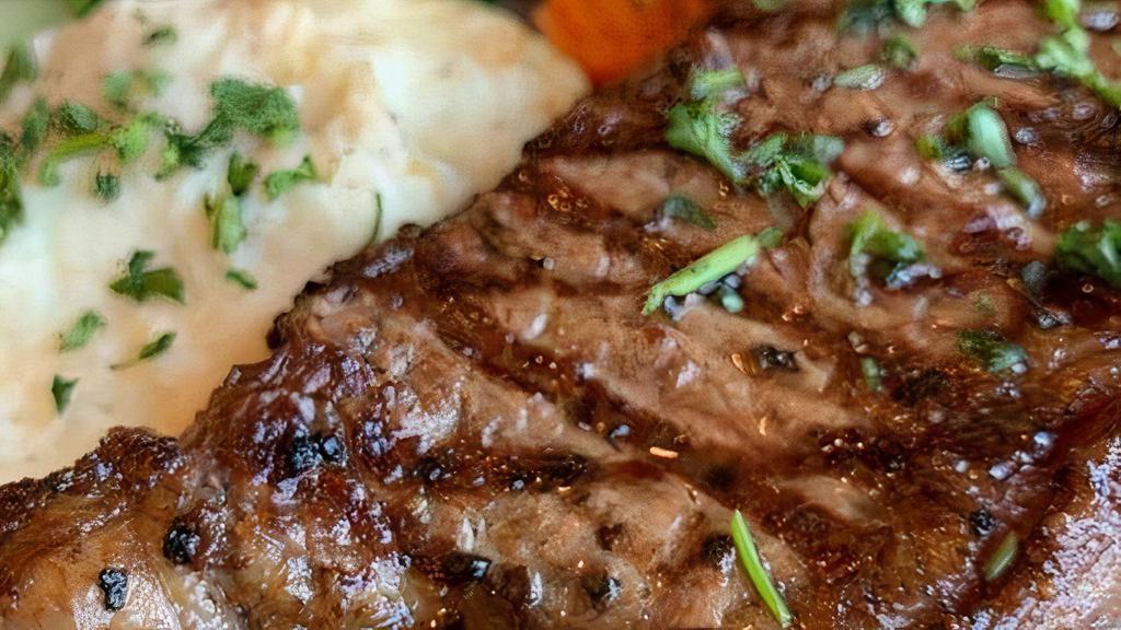 New York Strip · 12 oz. tender New York Strip topped with caramelized onions and sauteed mushrooms. Served with steamed vegetables and a side of roasted garlic mashed potatoes.