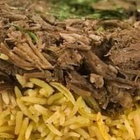 Baked Lamb · Lamb marinated with herbs and spices and slowly baked. Served on a bed of basmati rice with ...