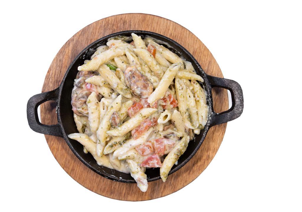 Creamy Pesto Pasta · Penne noodles with a creamy basil pesto sauce served with marinated tomatoes and mushrooms.