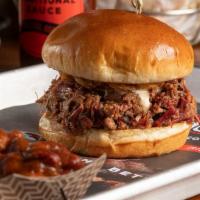 The Texan · Chopped brisket tossed in BBQ sauce with melted queso and haystack onions.