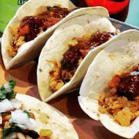 Tex-Mex Tacos · With brisket or chicken, topped with fresh pico de gallo, BBQ taco sauce, served with wedged...