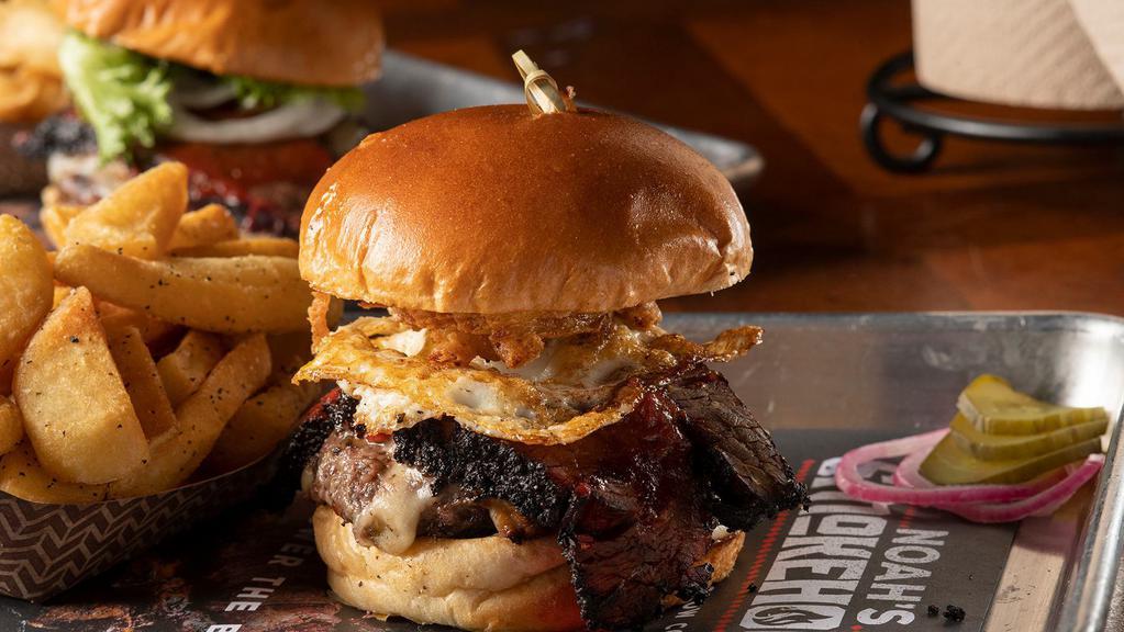 Rodeo Burger · Grilled beef patty, brisket, Pepper Jack cheese, , BBQ sauce, fried egg and haystack onions.