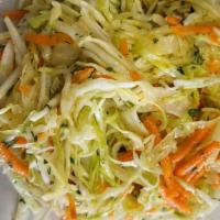Cabbage Salad · Thinly sliced cabbage mixed w/ grated carrots and dill vinaigrette.
