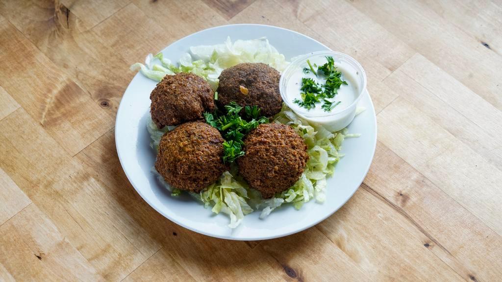 Falafel (4) · Seasoned ground chickpeas blended with fresh herbs and Mediterranean spices, served with tahini sauce.