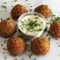 Falafel (6 Pc) · Ground chickpeas mixed with vegetables and spices deep fried.