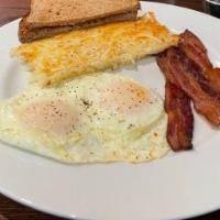 Easy Eggs · Made-to-order eggs, Jon's natural bacon and toast. Add pancakes for an additional charge.