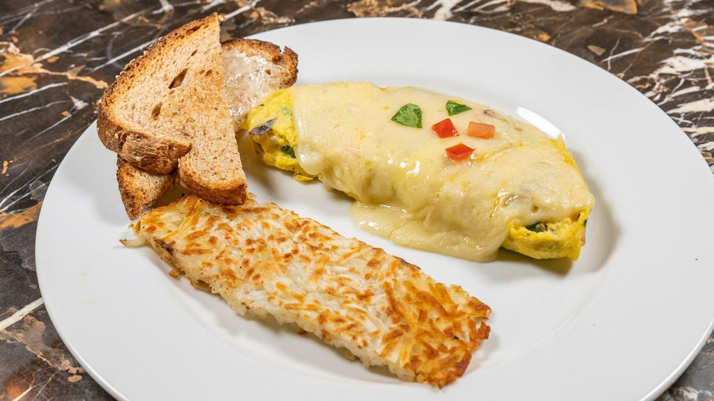 Veggie Omelette · Fresh mushroom, onion, Roma tomato, green bell pepper, baby spinach and Swiss cheese served with choice of toast.