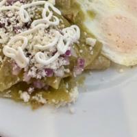 Chilaquileggs · Two Eggs, Corn Tortilla Strips, Red Onion, And Salsa Verde Topped with Queso Fresco and Crem...
