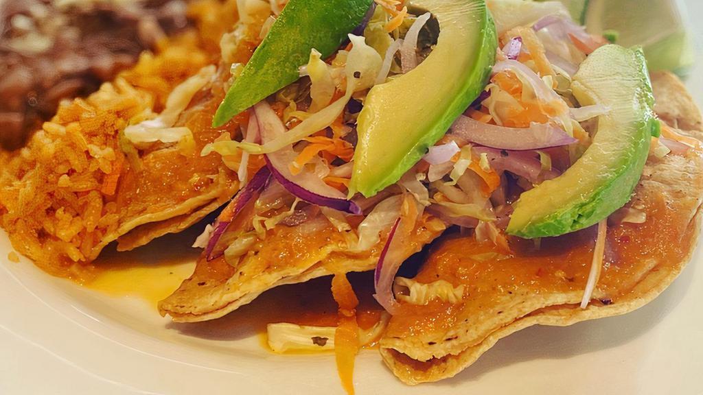 Shrimp Tacos · Three Corn Tortillas Fried Crispy and Stuffed with Sautéed Shrimp and Cocktail Sauce. Served with Avocado, Mexican Slaw and Lime. Includes Mexican Rice and Beans.