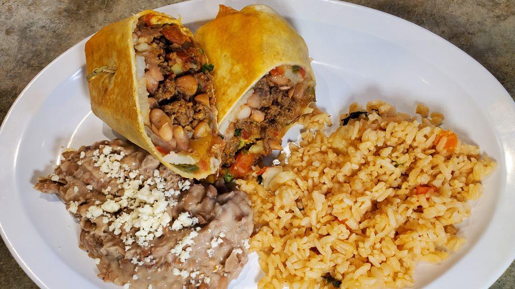 South Of The Border Burrito · Flour tortilla stuffed with chorizo sausage, marinated carne asada, Mexican potatoes, guacamole, shredded cheese served with tater tots.