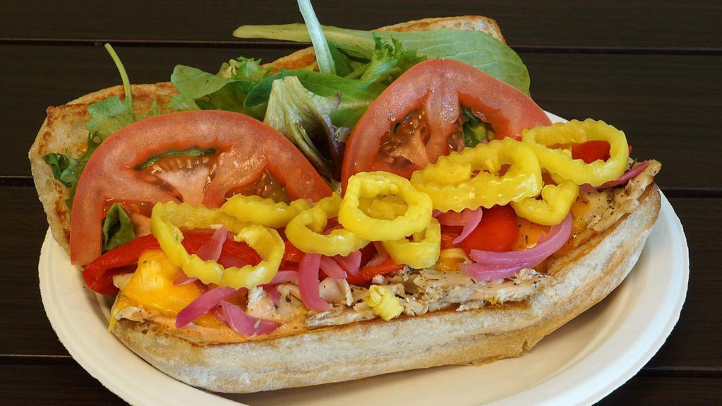 Jc'S Sub · Roasted chicken under cheddar with banana peppers, roasted red onions, roasted red peppers, tomatoes, chipotle ranch, and organic greens on a ciabatta roll.