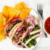 Deshebrada Tacos · Two tacos. Beef short rib, grilled onions, jalapeño rajas, cilantro and pickled red onion. S...