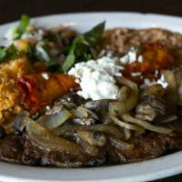 Carne Asada · Charbroiled angus skirt steak topped with grilled spanish onions, poblano rajas and mushroom...
