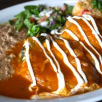 Chiles Rellenos · 2 lightly battered, cheese stuffed poblano peppers. Topped with a mild tomato sauce and crem...