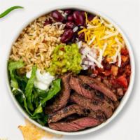 Carne Asada Craze Bowl  · Grilled steak topped with sour cream, salsa, jalapeno, lettuce, refried beans, onions, and c...