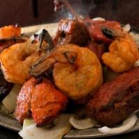 The Mixed Grill Madras · An assortment of chicken, tikka, roti kebab, seekh kebab, tandoori chicken, and tandoori shr...