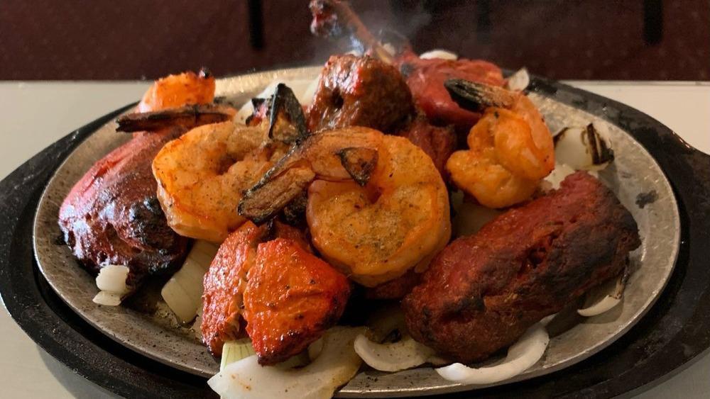 The Mixed Grill Madras · An assortment of chicken, tikka, roti kebab, seekh kebab, tandoori chicken, and tandoori shrimp.