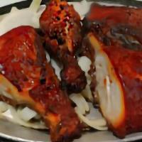 Tandoori Chicken · Spring chicken marinated in a puree recipe then broiled on charcoal served to sizzle with sa...