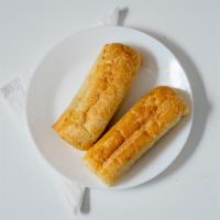 Garlic Bread · Crispy Italian roll perfectly slathered in garlic butter toasted until golden brown.