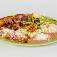 Tampiqueña · A ribeye steak, served with cheese enchilada, rice, guacamole, beans, salad and corn tortill...