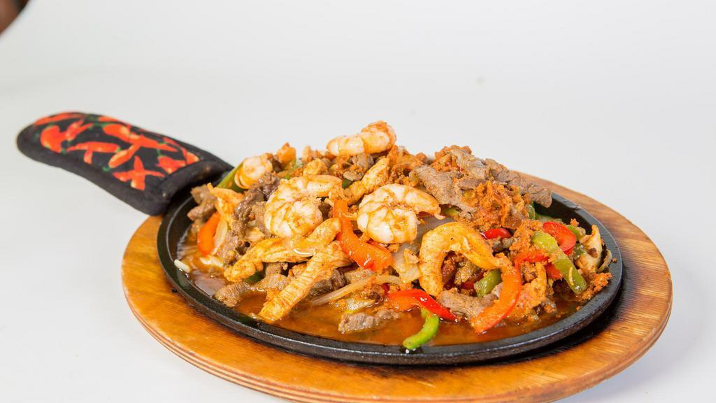 Sánchez Fajitas · Prepared with shrimp, beef, chicken, chorizo, bell peppers, onions, rice, beans, lettuce, pico de gallo, sour cream and guacamole.