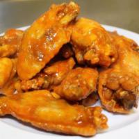 Buffalo Wings · Spicy or BBQ. Served with blue cheese sauce or ranch dressing.