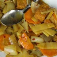 Curry Tofu · Fried tofu sauteed in a yellow curry sauce with onions, bamboo shoots, and carrots