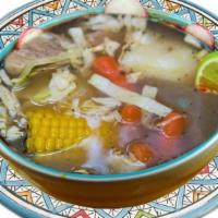 Caldo De Res · Beef soup boiled with potato, carrots, cornk garnishes such as onion, silantro, lime, rice.