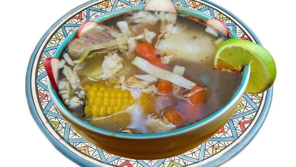 Caldo De Res · Beef soup boiled with potato, carrots, cornk garnishes such as onion, silantro, lime, rice.