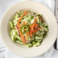 Cucumber Salad · Fresh mix of cucumber, red cabbage, carrots, red onion, and scallions in our delicious tangy...